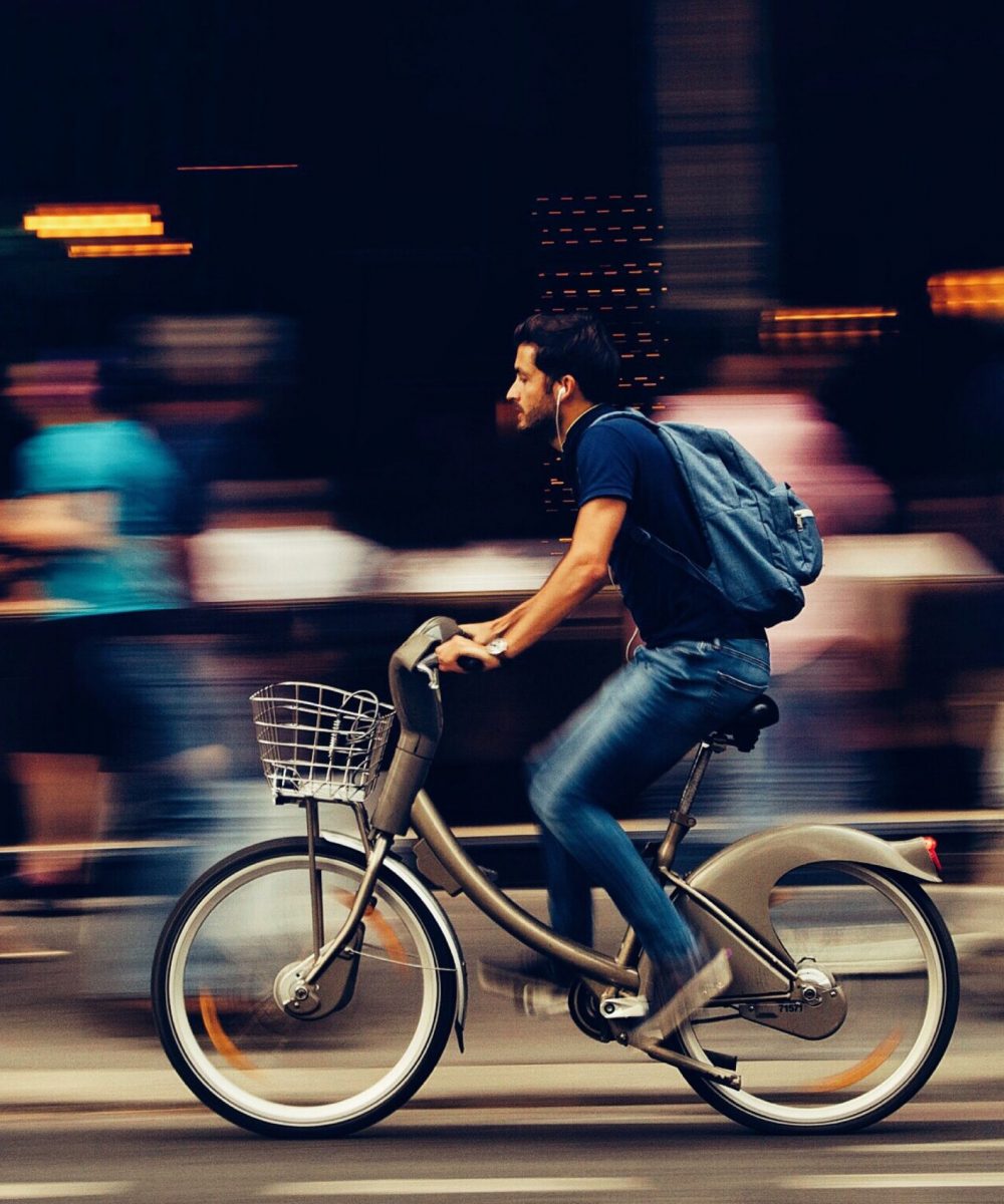 man-riding-bicycle-on-city-street-310983