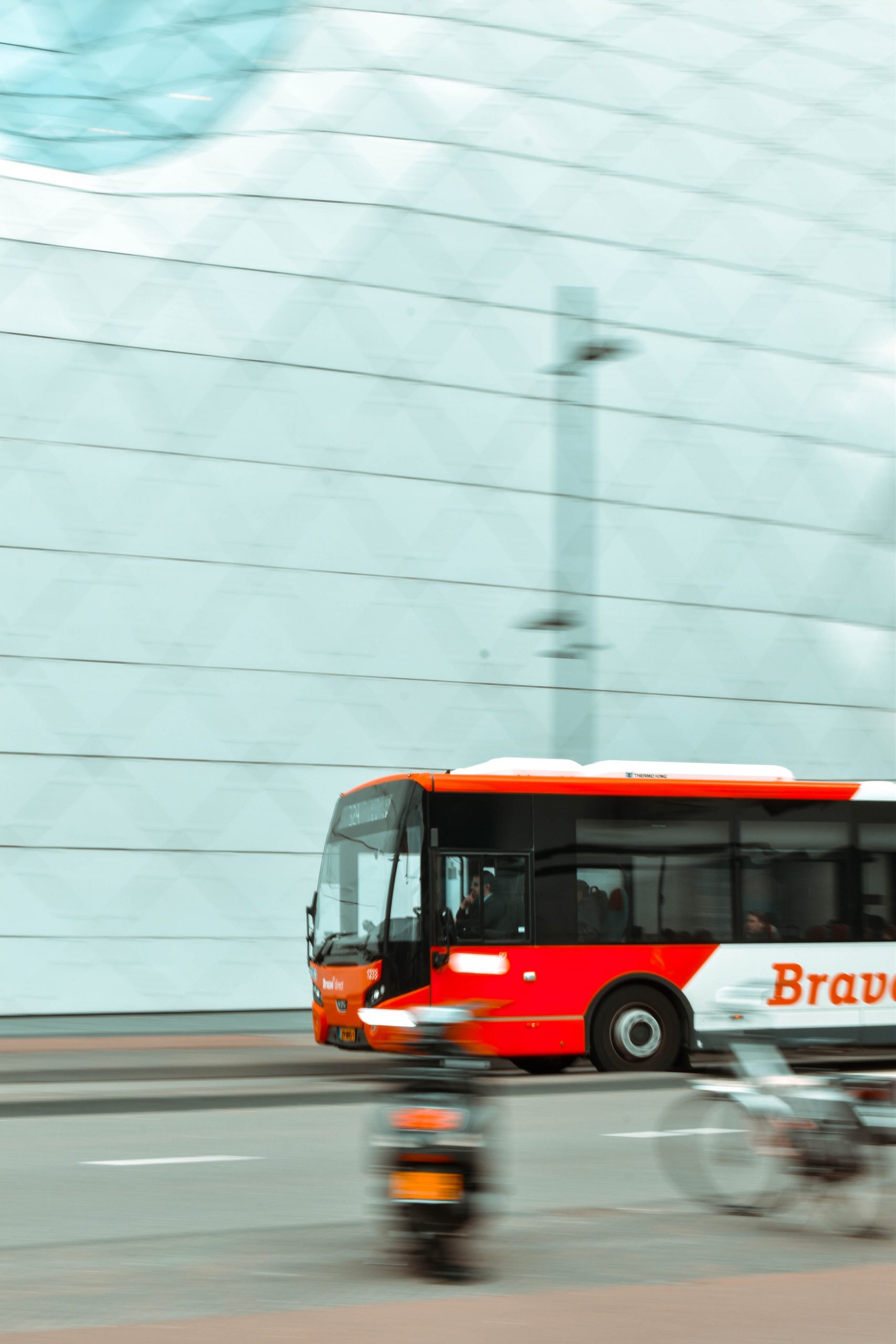 selective-focus-photography-of-red-and-white-bus-2085503
